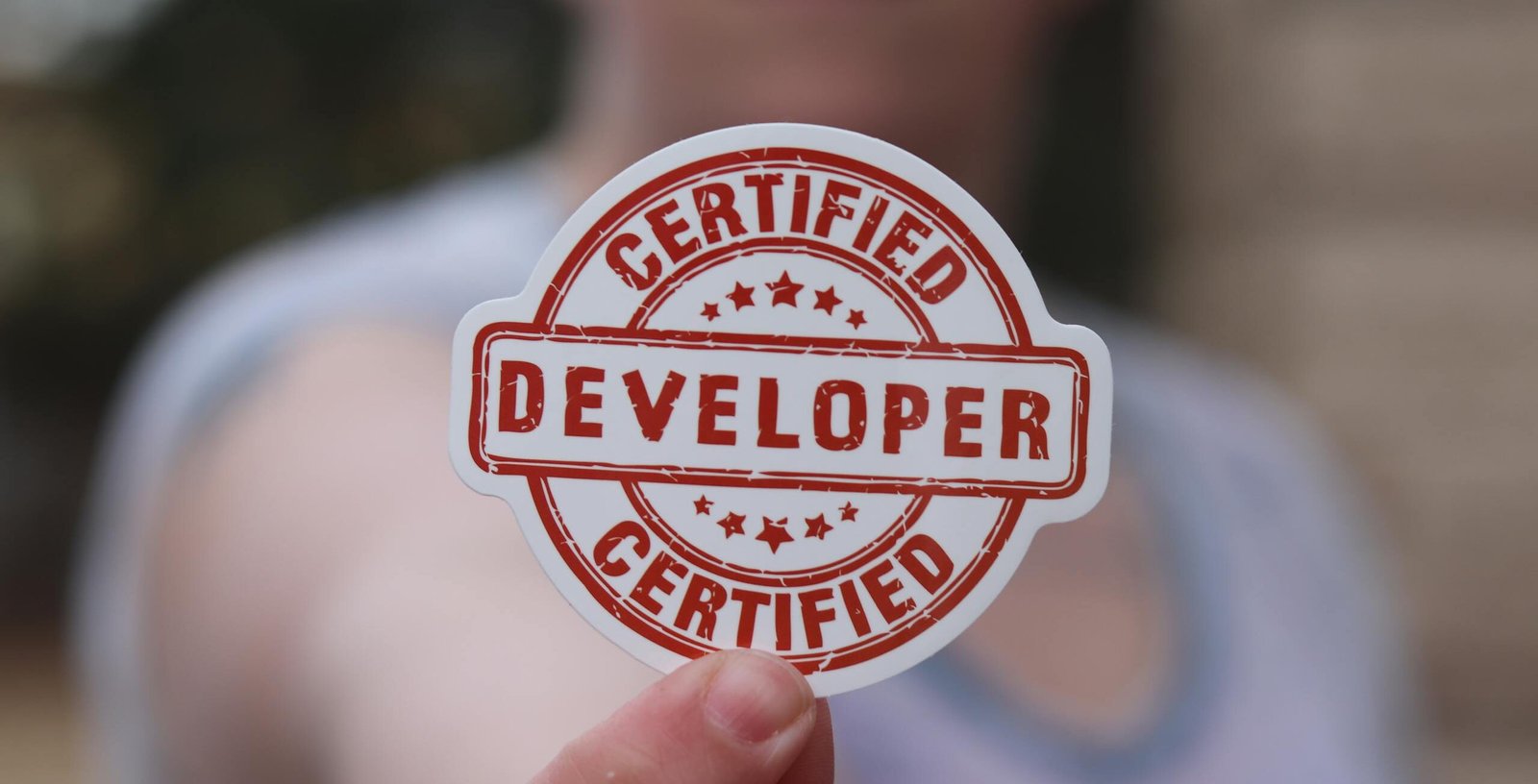 A software engineer with essential skills, showing his Certified Developer badge.